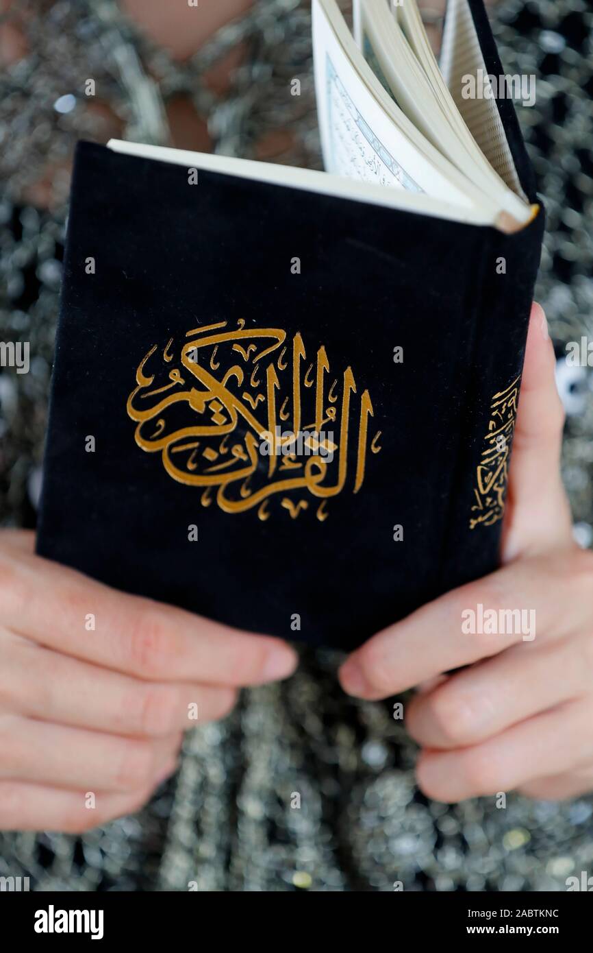 Woman reading the Noble Quran. Close-up Stock Photo - Alamy