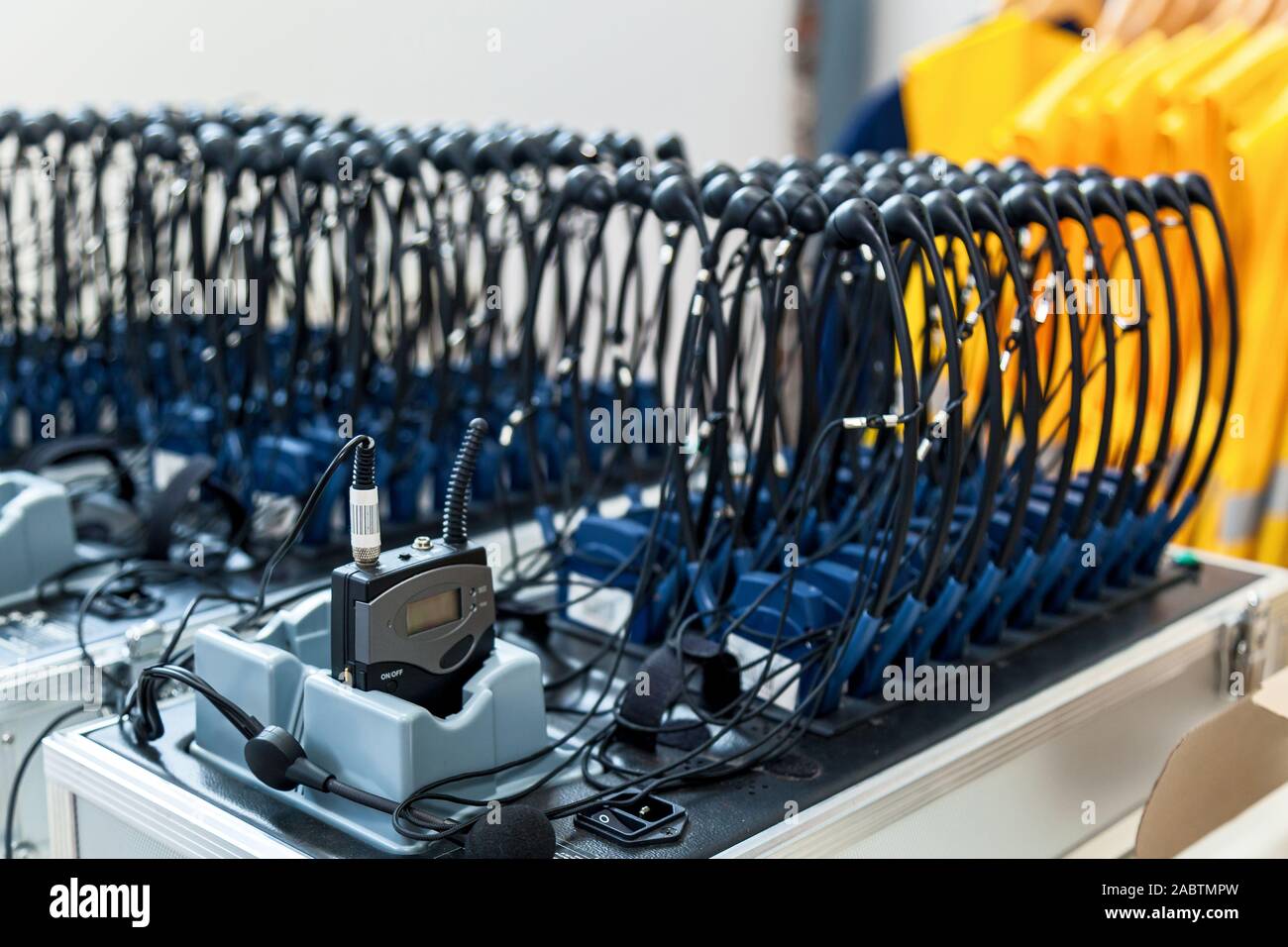 A lot of headphones are placed in rows. Stock Photo