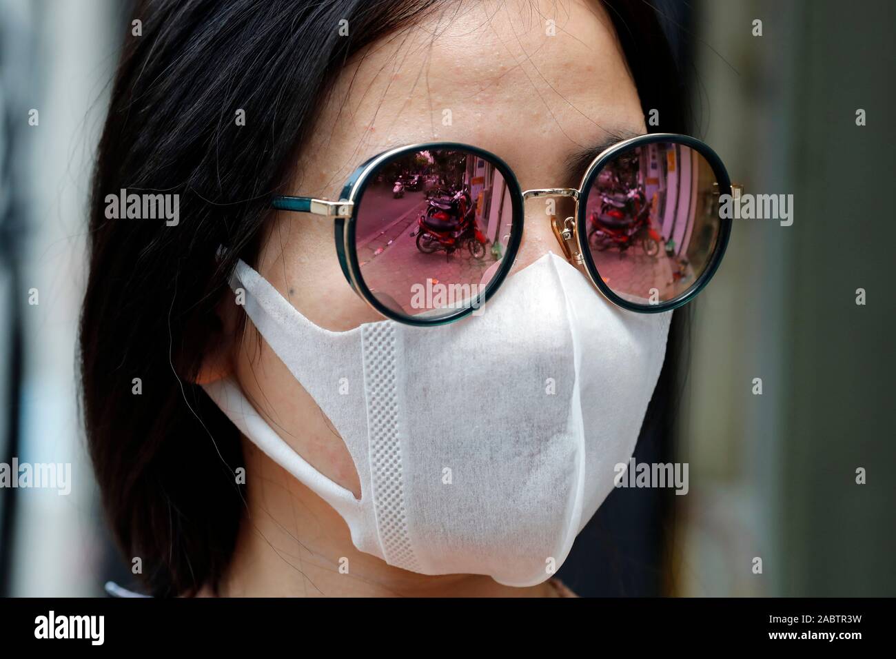 Young woman in the street  with protection mask at her face. Hanoi. Vietnam. Stock Photo