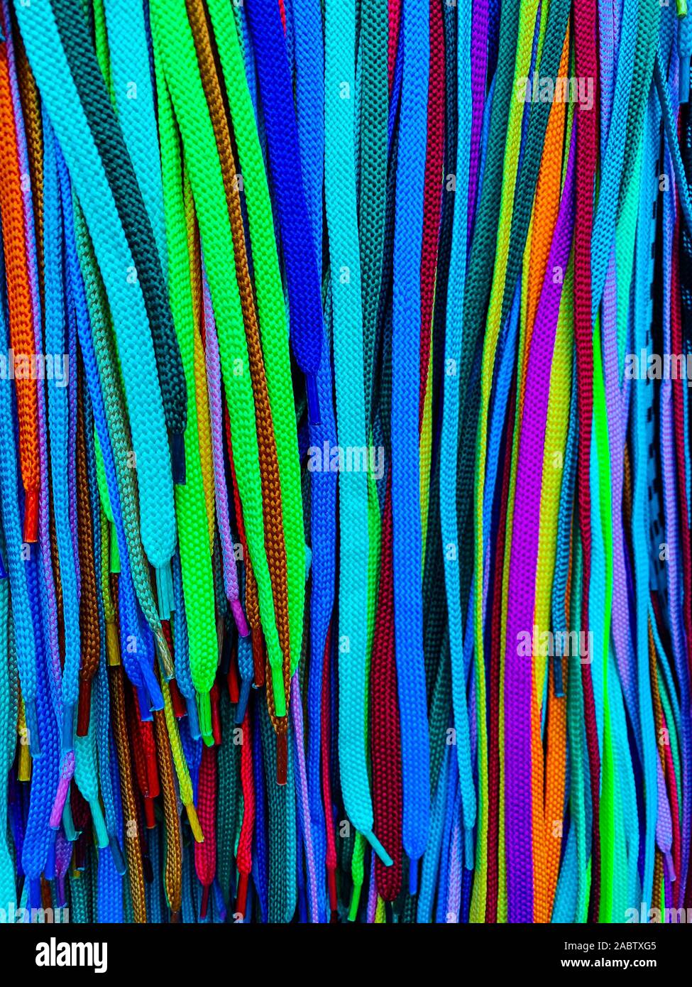 Lots of multi-colored shoelaces as a colored background Stock Photo - Alamy