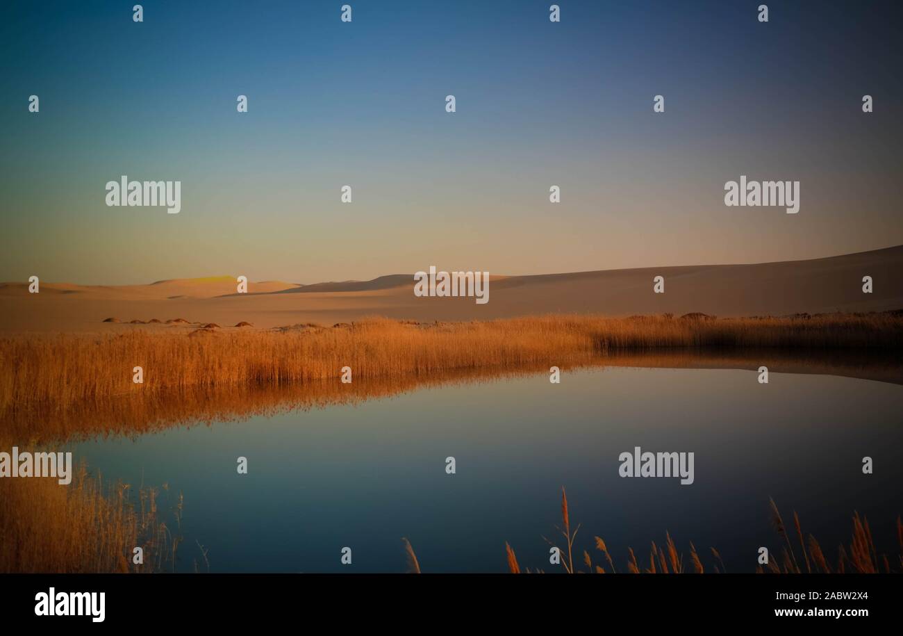 Panorama landscape at Great sand sea and lake around Siwa oasis at sunset in Egypt Stock Photo