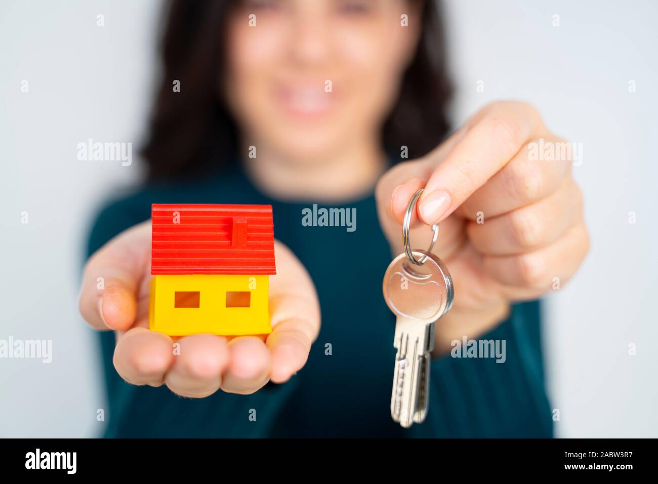 Female hand holding house key, real estate agent Stock Photo - Alamy