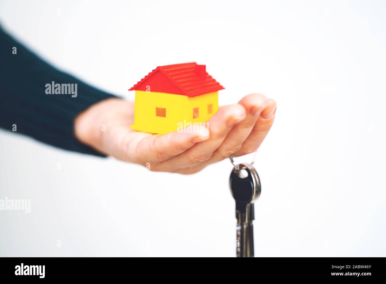 Female hand holding house key, real estate agent Stock Photo - Alamy