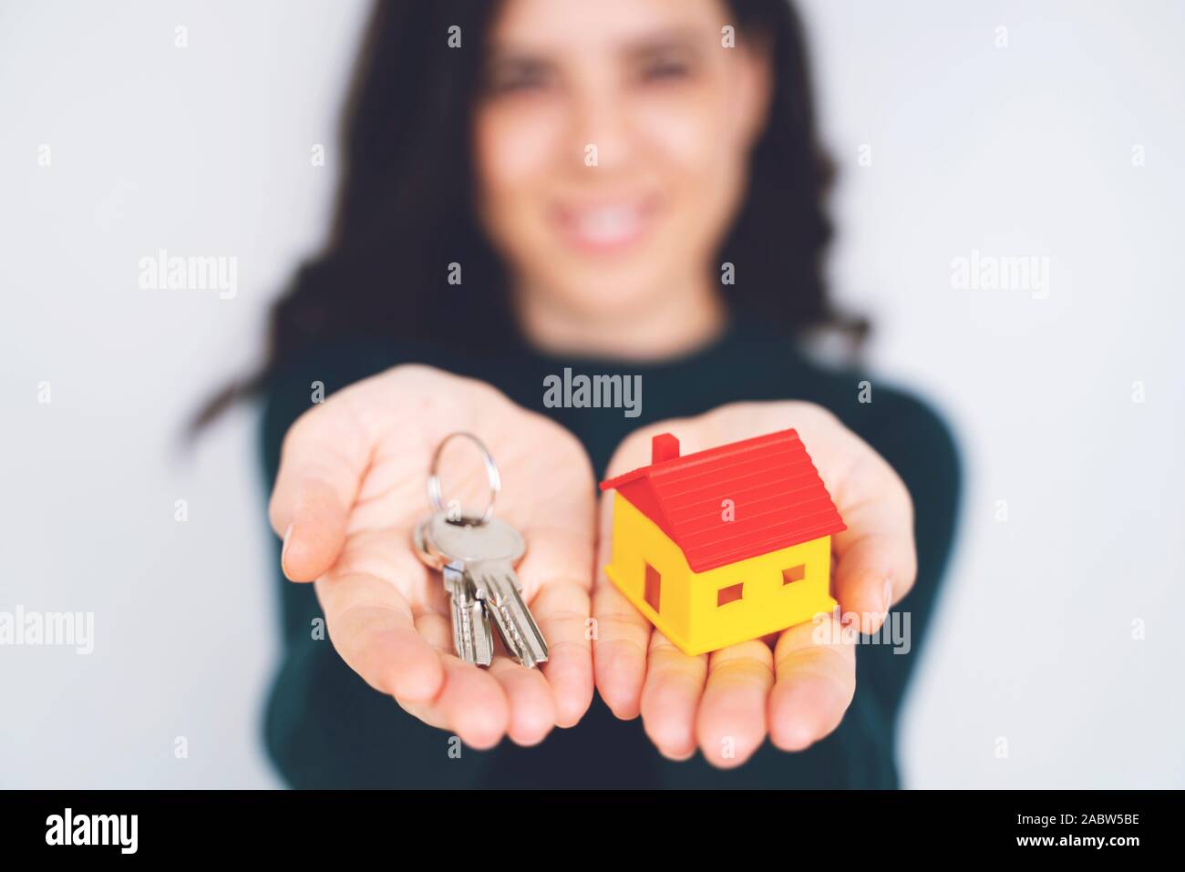Female hand holding house key, real estate agent Stock Photo - Alamy