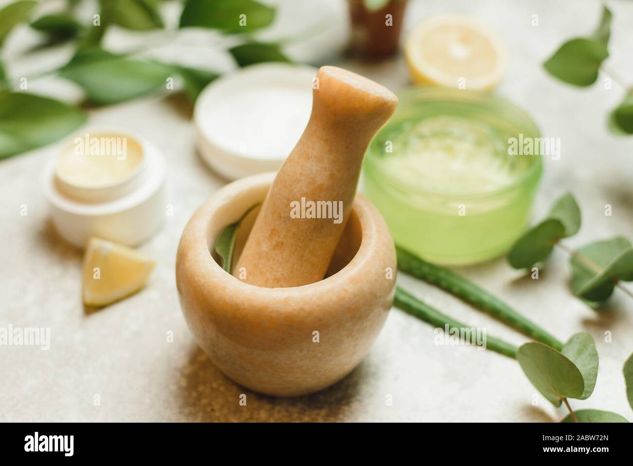 mixing ingredients to create cosmetics in a marble mortar. Herbal ...