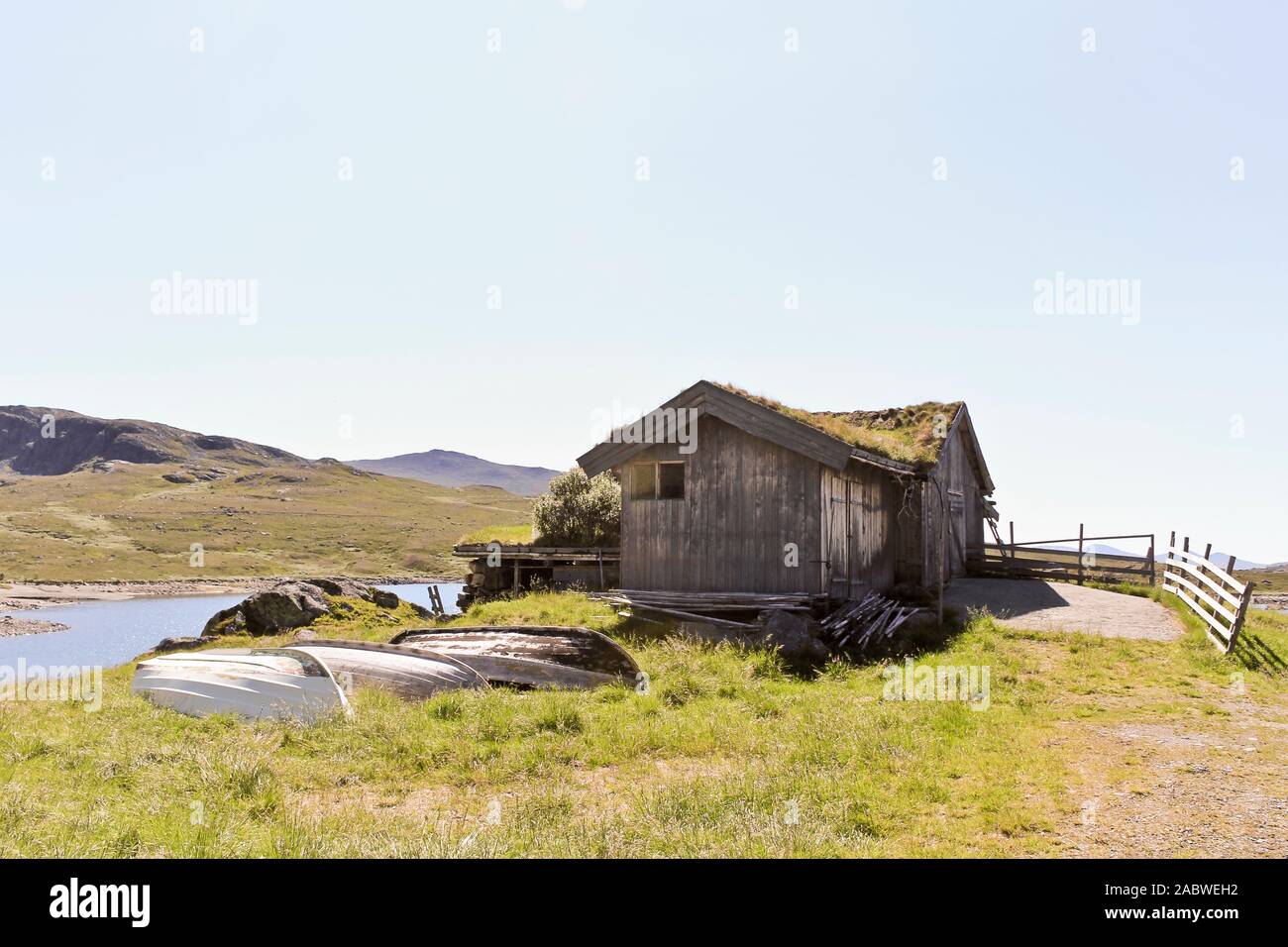 Small Idyllic Hut With Fishing Boats Near The Vavatn Lake In
