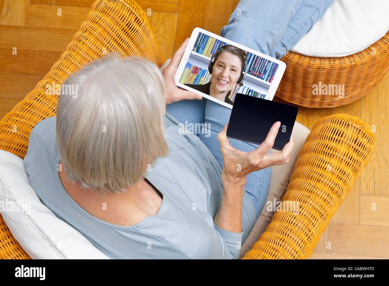 e-id concept: senior woman using a video identification service to open a new bank account with her tablet computer Stock Photo