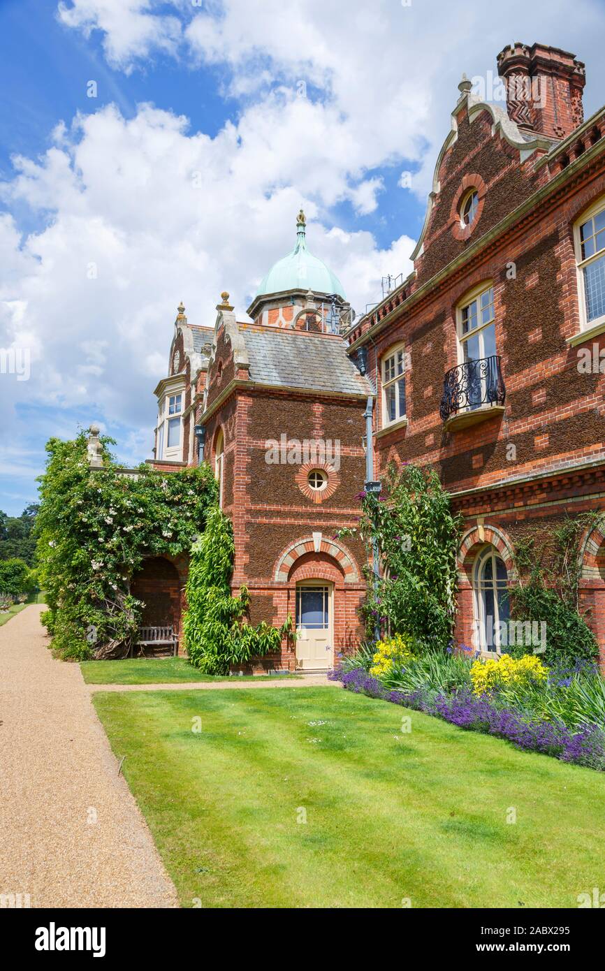 View of the rear facade of Sandringham House, the Queen's Jacobethan style Norfolk country house retreat, with fine brickwork and flower borders Stock Photo