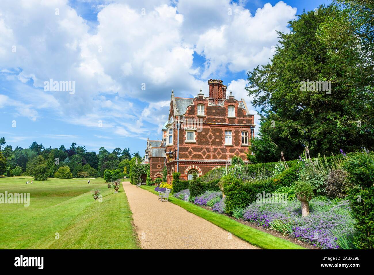 View of the rear facade of Sandringham House, the Queen's Jacobethan style Norfolk country house retreat, with fine brickwork and flower borders Stock Photo