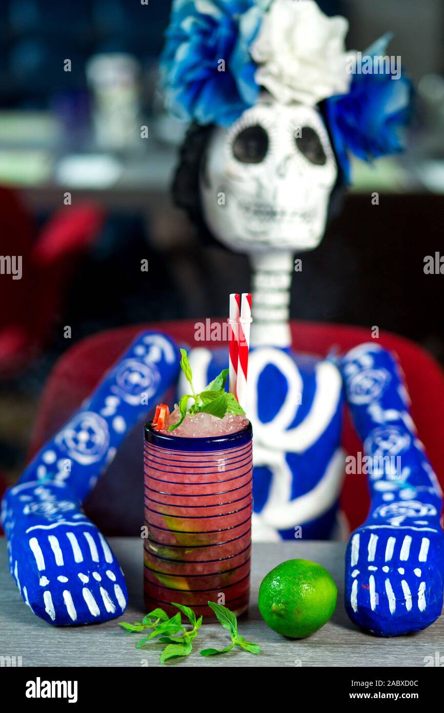 strawberry mojito glass next to blue mexican skeleton doll Stock Photo ...
