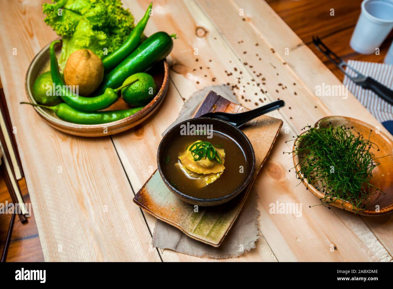 a bowl of japanese dumpling soup, vegetable and fruit plate and herb bowl Stock Photo