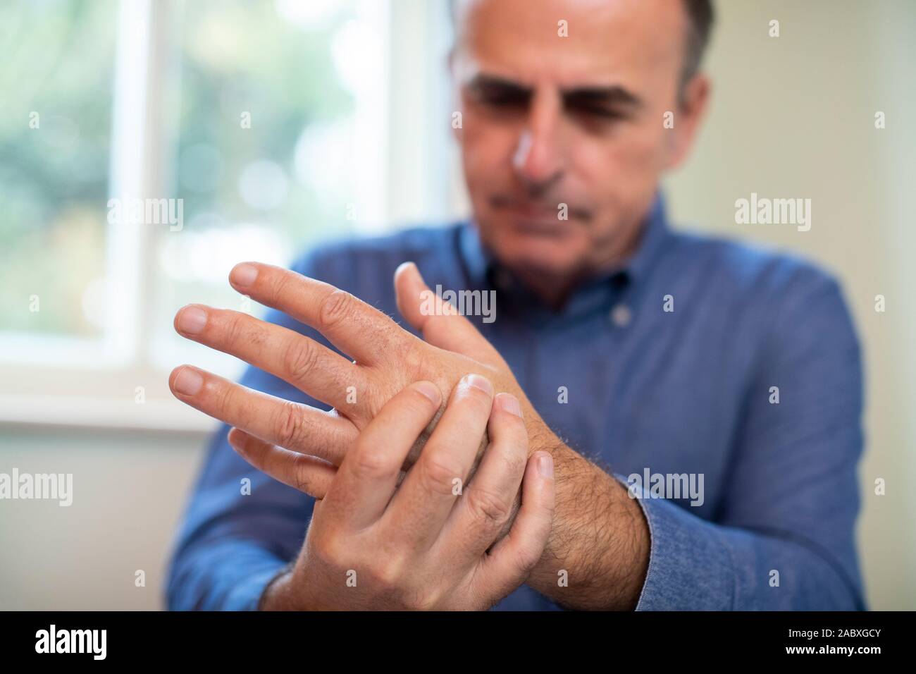 Mature Man Suffering With Repetitive Strain Injury Stock Photo
