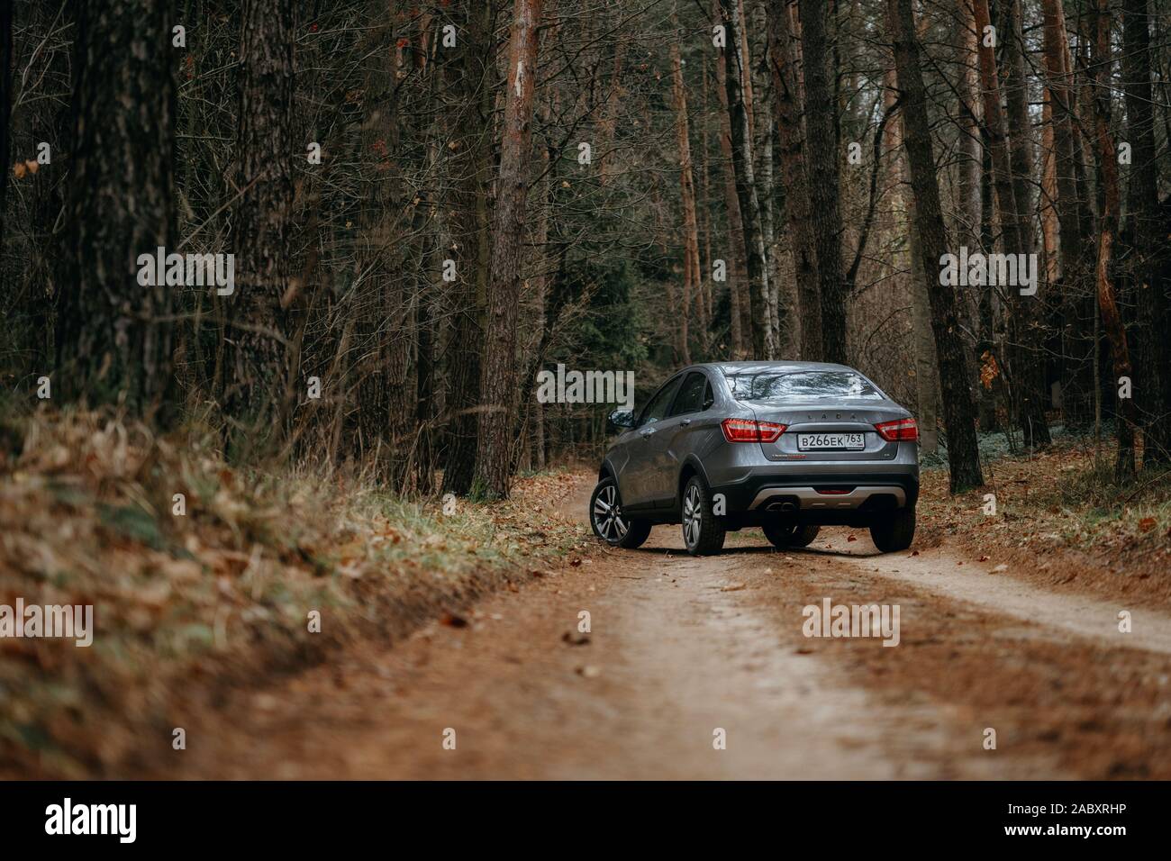 Minsk, Belarus - 21 November, 2019: Lada Vesta AMT robot on country road n autumn forest landscape. Stock Photo