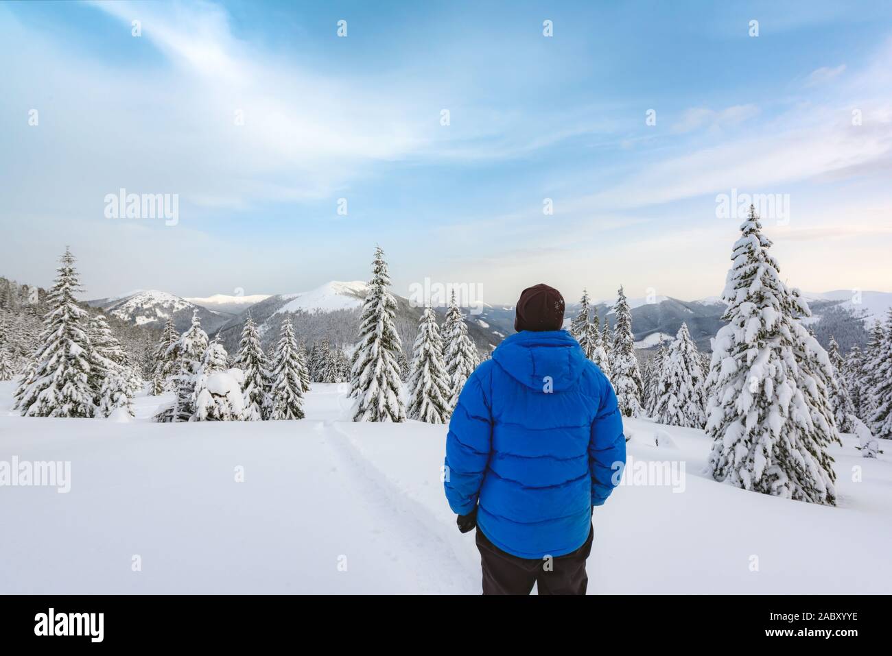 Alone tourist with a backpack in the high mountains in winter time. Travel concept Stock Photo