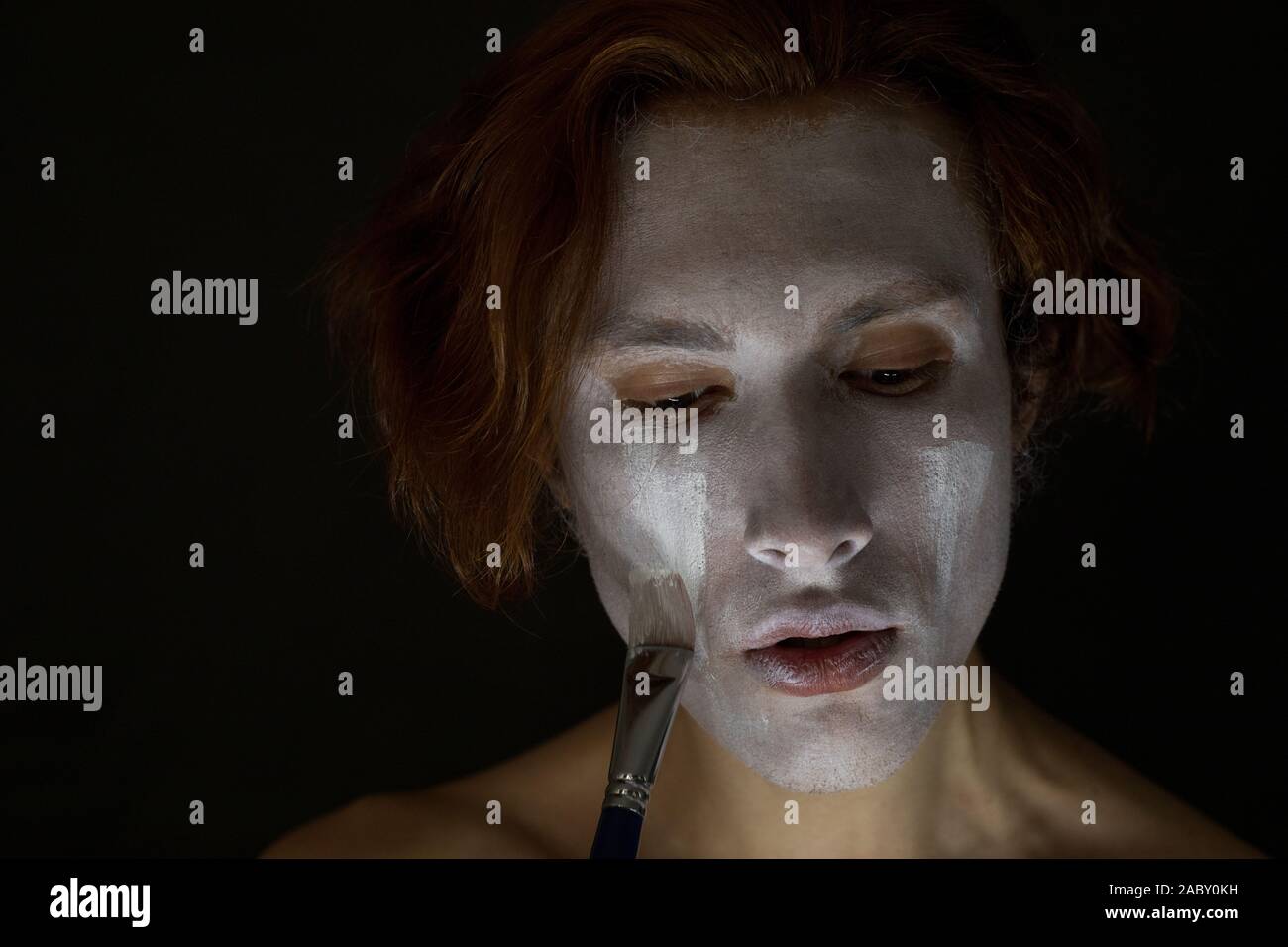 Man gets white paint on the face Stock Photo - Alamy