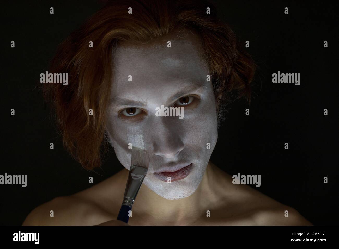 Man gets white paint on the face Stock Photo - Alamy