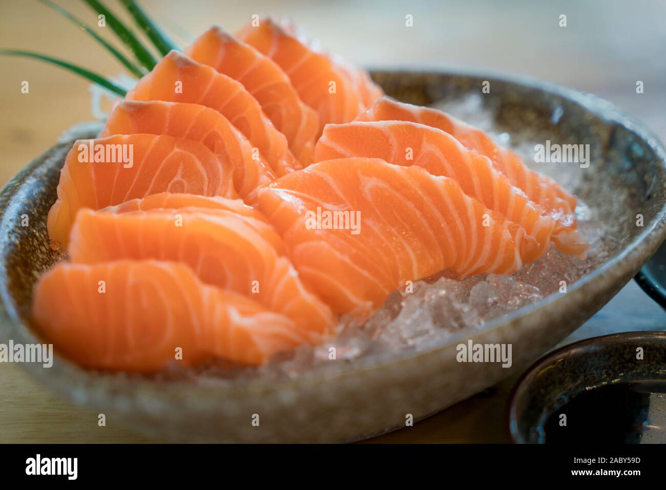 Raw salmon slice or salmon sashimi in Japanese style fresh serve on ice in bowl. Japanese traditional food or with low calories and high nutrition and Stock Photo