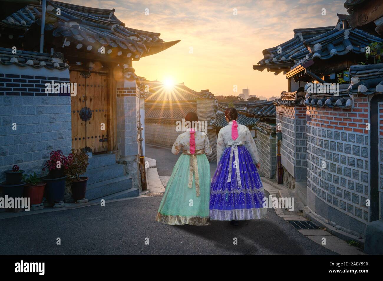 Two Korean women wear hanbok Korea's tradition dress to visit Bukchon Hanok Village in Seoul,  South Korea. Tourism, summer holiday, or sightseeing Se Stock Photo