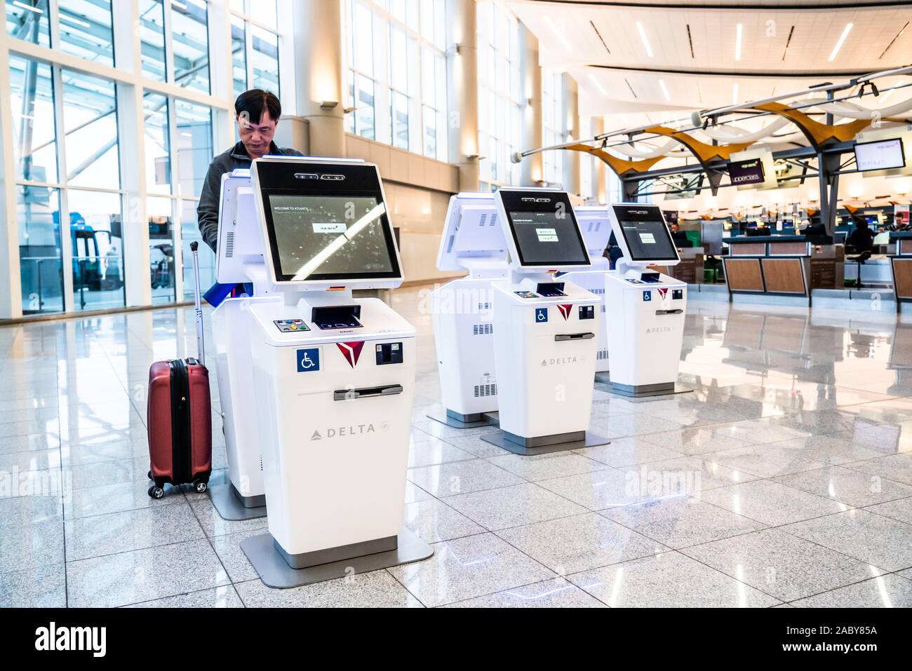 A passenger uses a Delta Airlines selfservice checkin kiosk at the International Terminal of