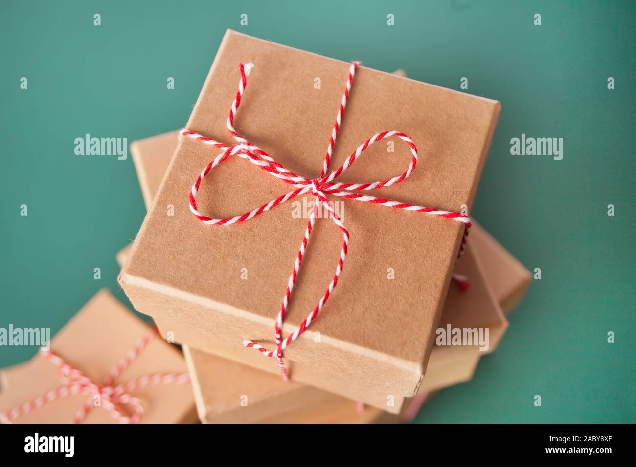 Five different sizes Christmas gift boxes on the green background. Stock Photo