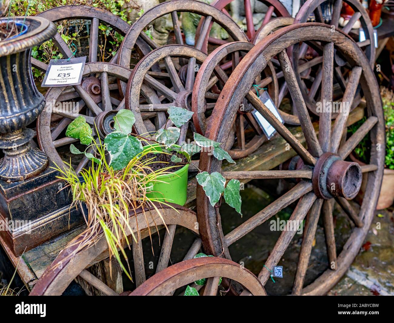 Close up of a selection of antique wooden cart wheels for sale Stock