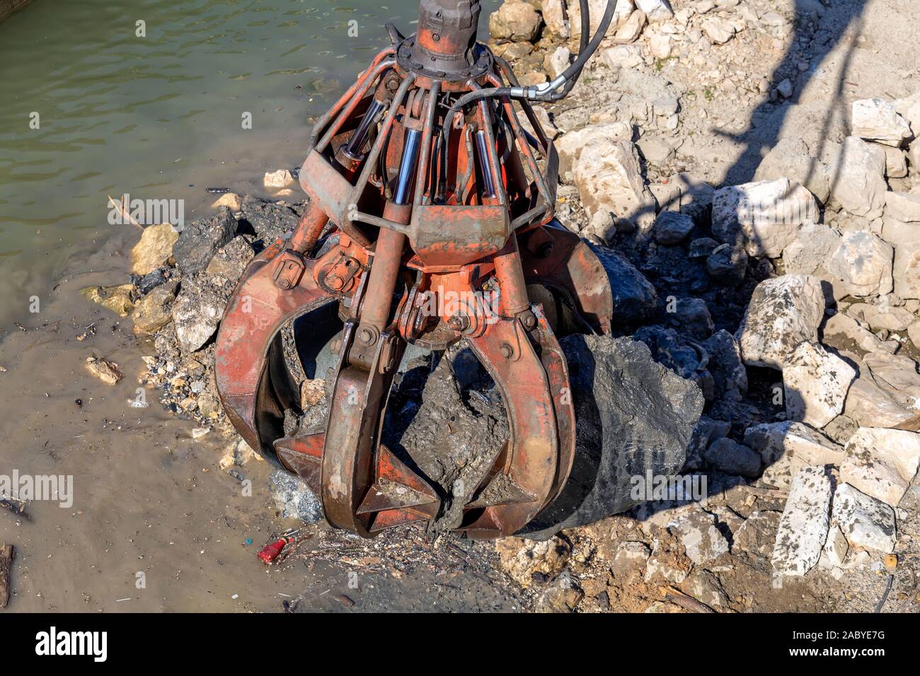 Hydraulic multi valve crab bucket cleaning riverbed water course Stock
