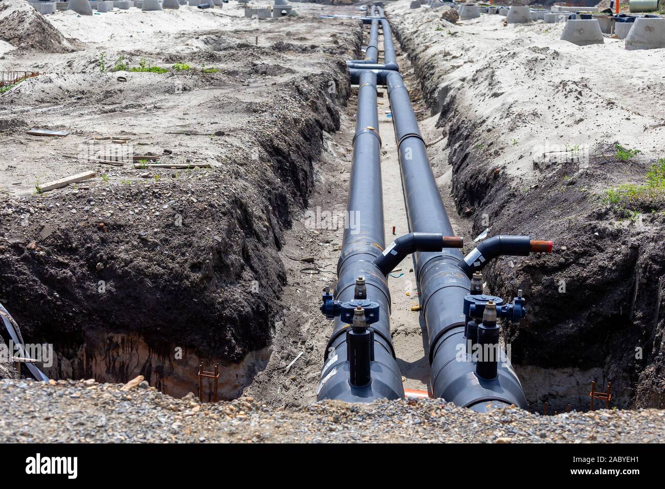 Insulated pipes for underground district heating. Connecting a new building  to heat system Stock Photo - Alamy