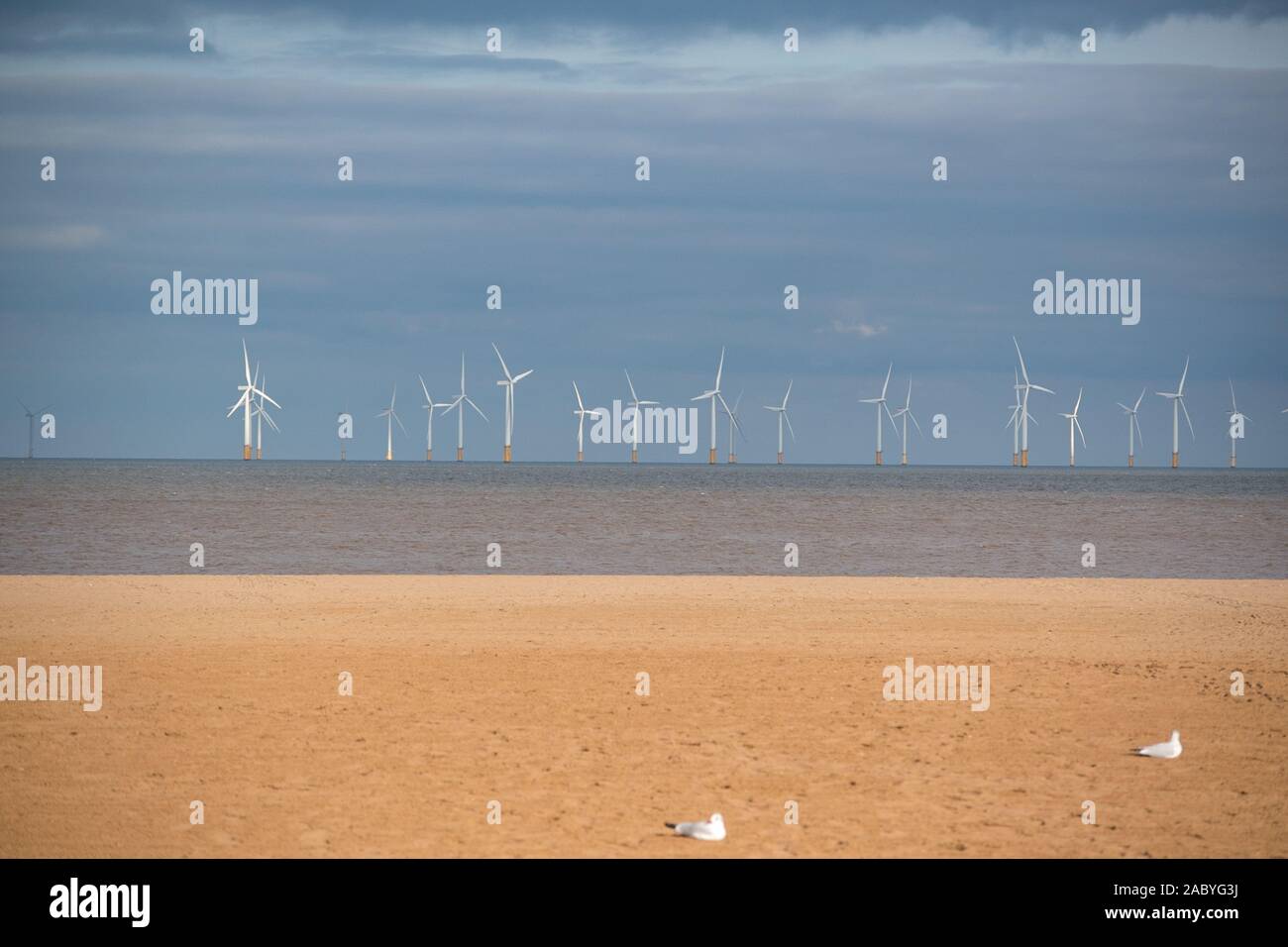 Off shore wind farms viewed from the East Coast holiday town of Skegness Beach in Lincolnshire England UK. Stock Photo