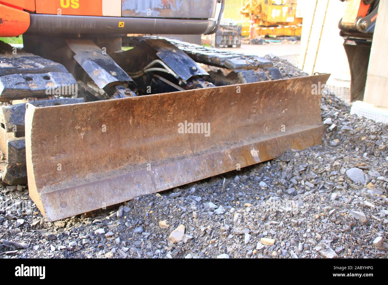 Plowing blade on an excavator was parked on gravel Stock Photo