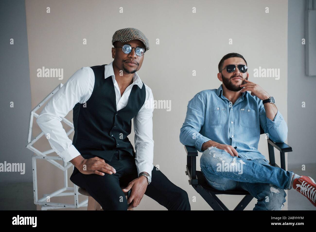 Dream of success. Photo of mixed race bearded friends have photoshoot ...