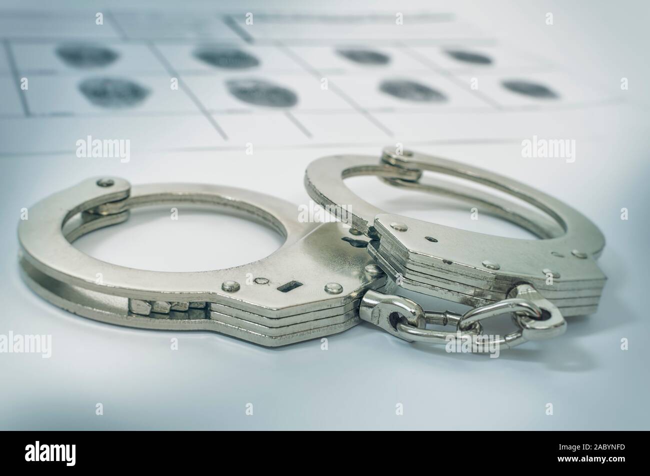 Police Handcuffs on fingerprints crime page file. Selective focus. Crime and violence concept Stock Photo