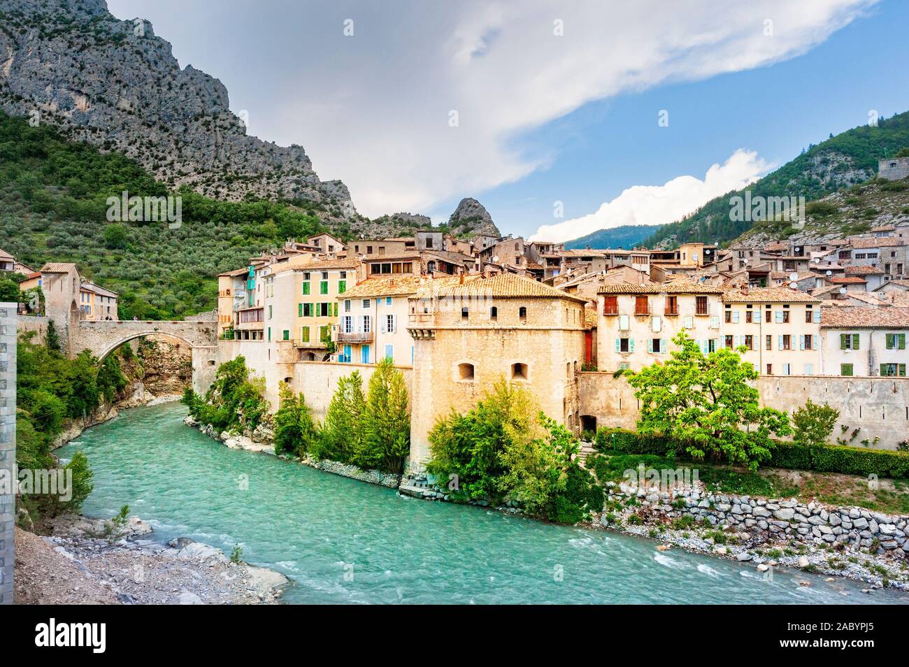 In the Alpes-de-Haute-Provence  the medieval walled town of Entrevaux lies above the river Var and below a mountaintop citadel. Stock Photo