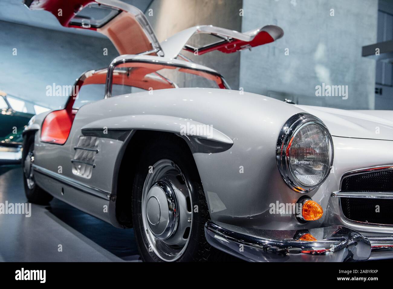 Doors wide open like a wings. Red vintage car on a auto show Stock