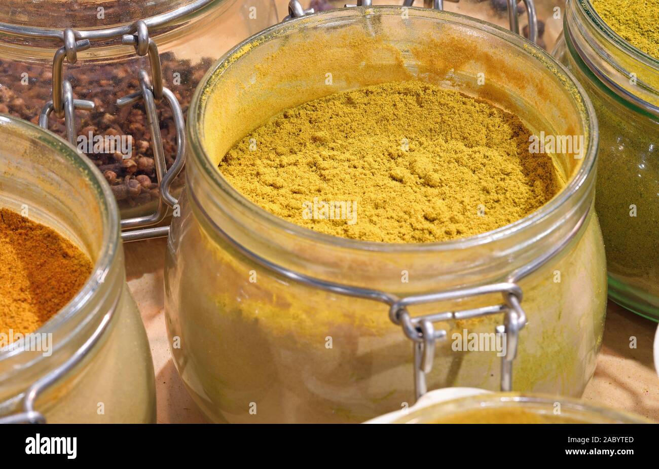 jar with yellow curry powder for sale at indian shop Stock Photo
