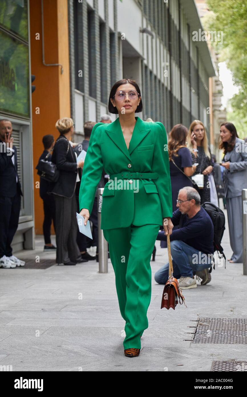 MILAN, ITALY - SEPTEMBER 19, 2019: Woman with green Givenchy jacket and  trousers before Emporio Armani fashion show, Milan Fashion Week street  style Stock Photo - Alamy