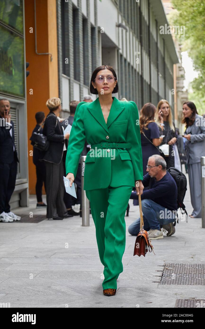 MILAN, ITALY - SEPTEMBER 19, 2019: Woman with green Givenchy jacket and  trousers before Emporio Armani fashion show, Milan Fashion Week street style  Stock Photo - Alamy