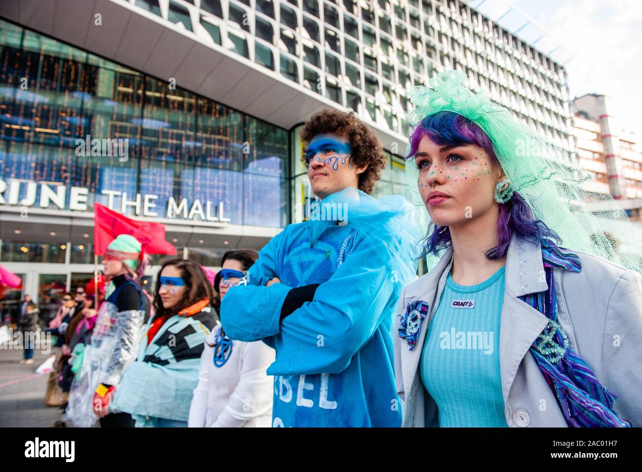 Two XR models waiting for the catwalk during the demonstration.In Utrecht, Extinction Rebellion Nederland organised an XR fashion action, against the consumerism during the Black Friday, in front of the Hoog Catharijne shopping mall which is one of the largest indoor shopping centres in The Netherlands. All the clothes that they used were second-hand and up-cycled clothes. This follows the Fridays for Future, Youth Climate Strike movements. Stock Photo