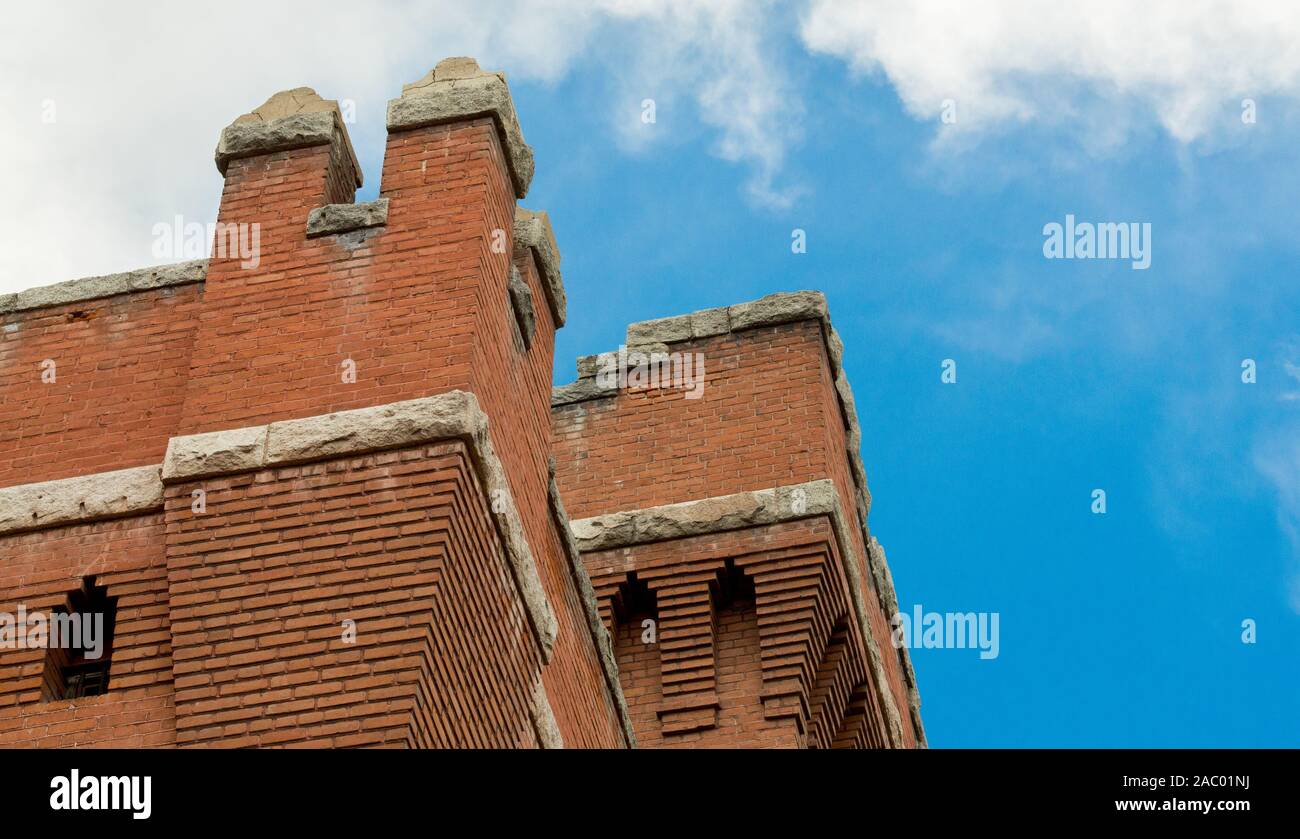 imposing vintage brick towers at Montana State prison museum against blue skies viewed from below Stock Photo