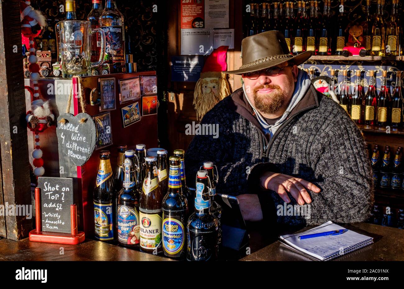 Edinburgh's Christmas 2019: A stall holder in Princes Street Gardens waiting on customers for his beer. Stock Photo