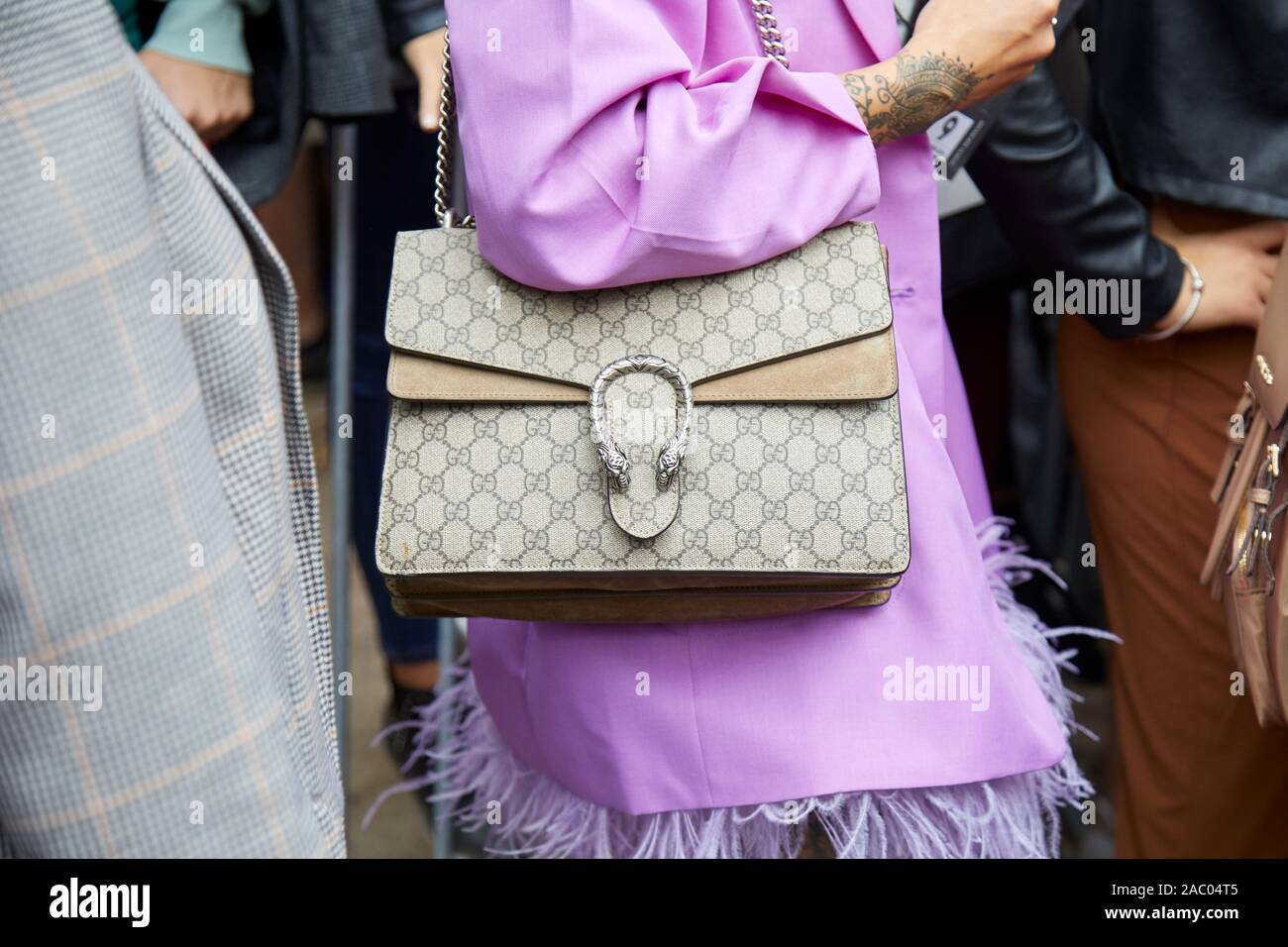 MILAN, ITALY - SEPTEMBER 19, 2019: Woman with Gucci bag and purple jacket  with feathers before Fendi fashion show, Milan Fashion Week street style  Stock Photo - Alamy
