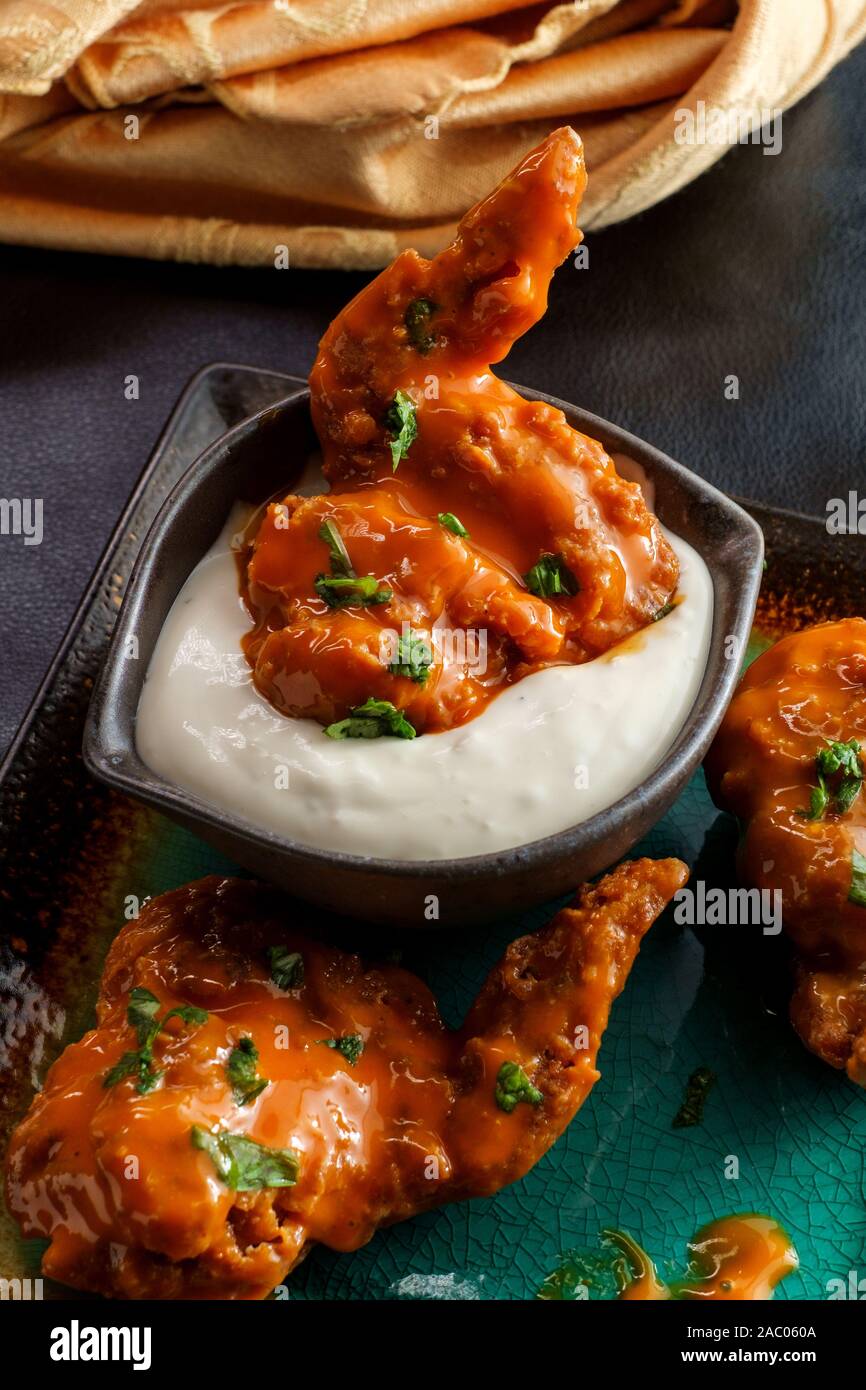 Hot and spicy buffalo wings with blue cheese dipping sauce Stock Photo