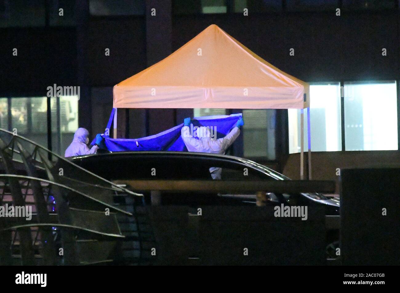 Forensic officers at the scene of an incident on London Bridge in central London after a terrorist wearing a fake suicide vest who went on a knife rampage was shot dead by police. Stock Photo