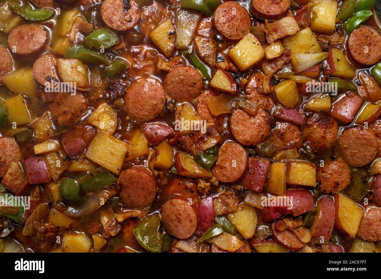 Cooking Polish kielbasa potatoes onions and peppers hash Stock Photo