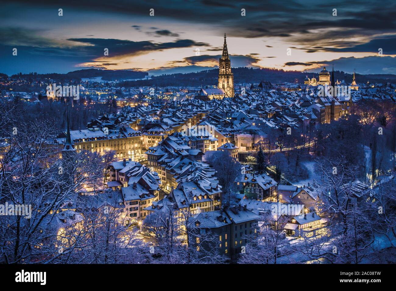 Winter evening sunset with snowy and illuminated buildings, Rosengarten, Bern, UNESCO, Switzerland Stock Photo