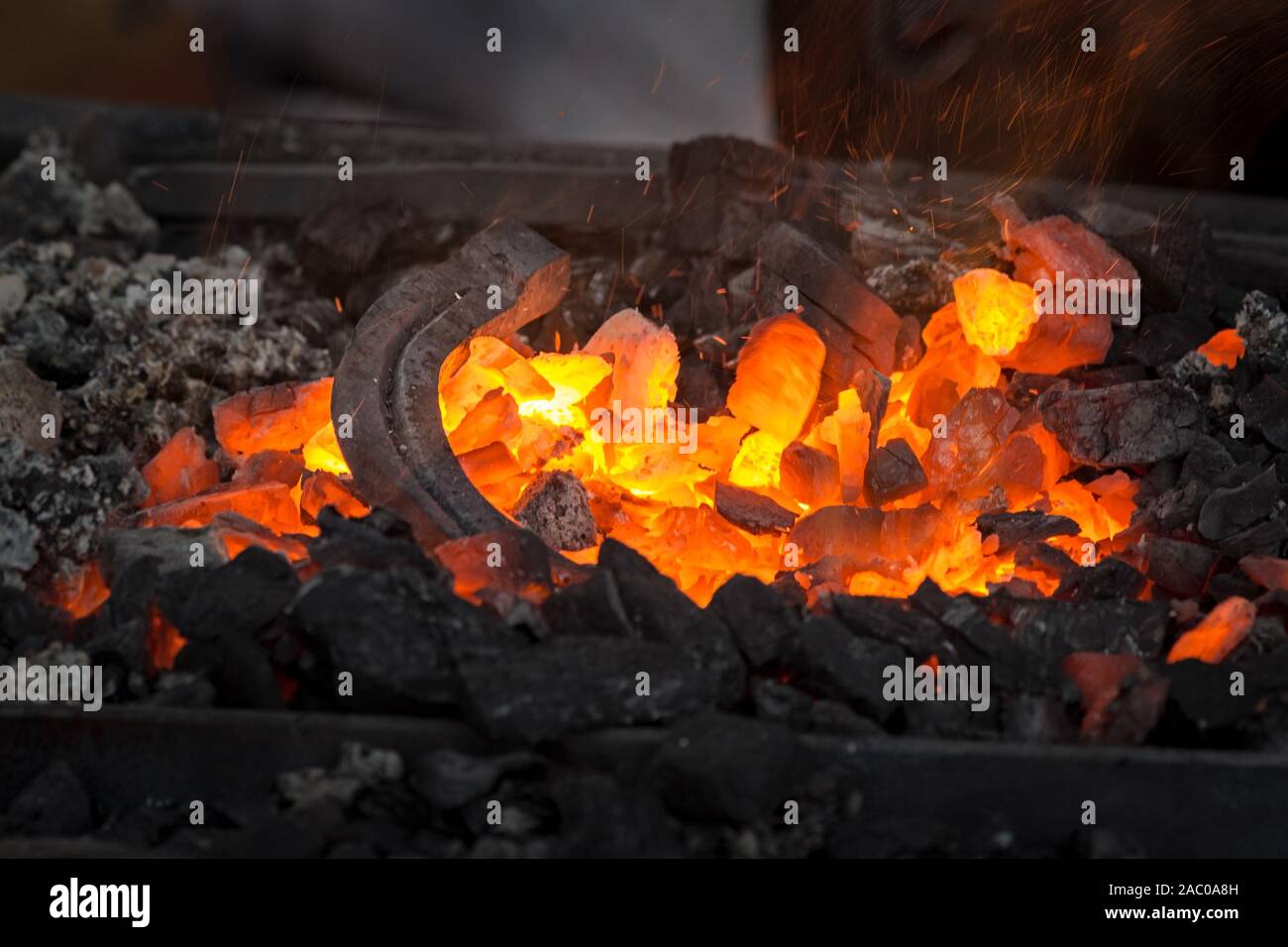 Horseshoe heating for Embers glow in a iron Fire, heat, coal and ash with flying