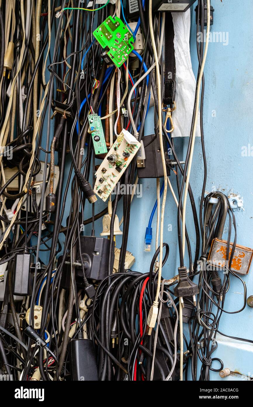 Old unused power cords for various devices in the market for sale Stock Photo
