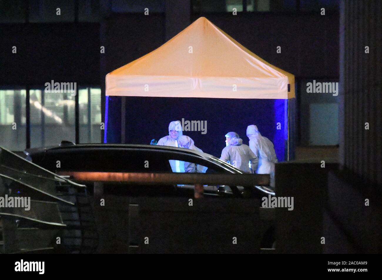 Forensic officers at the scene of an incident on London Bridge in central London after a terrorist wearing a fake suicide vest who went on a knife rampage was shot dead by police. Stock Photo