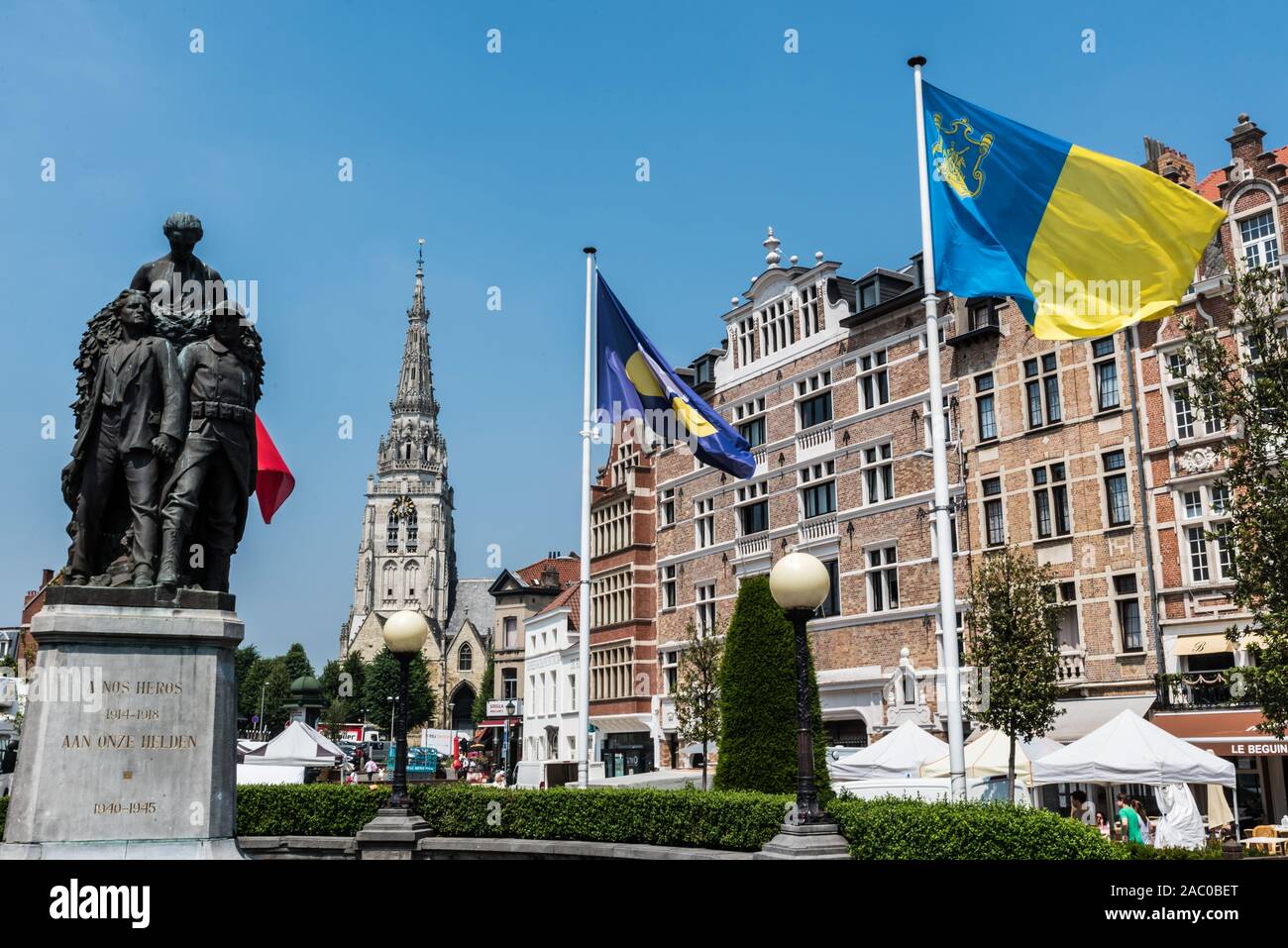 Anderlecht, Brussels / Belgium - 06 26 2019: Flags of Brussels, Anderlecht and Belgium at the statue of the World War at the Place de la Vaillance Dap Stock Photo