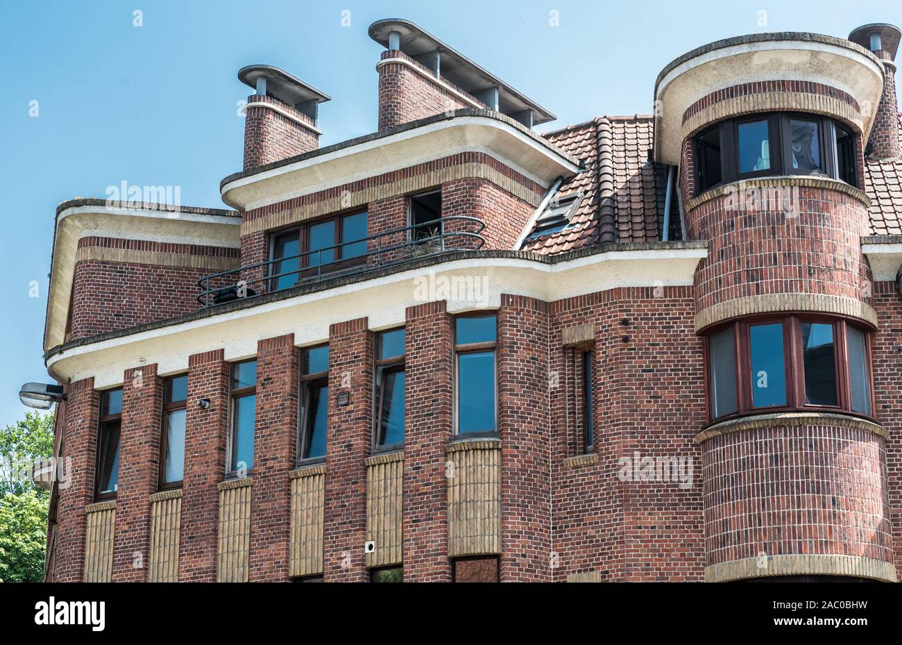 Anderlecht, Brussels / Belgium - 06 26 2019: Brick stone shaped facade of a residential apartment in modernist style Stock Photo