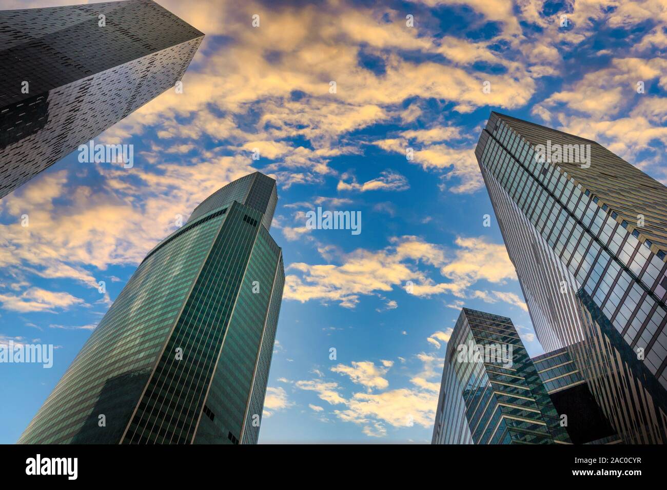 Silhouettes of skyscrapers in the city on a sunset sky background. Stock Photo
